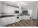 Well-lit kitchen with white cabinets, modern appliances, and laminate floors, offering a functional and stylish space at 2085 Friar Tuck Ln, Orange City, FL 32763