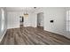 Bright living room with laminate flooring, arched doorway, neutral paint, and chandelier fixture at 2085 Friar Tuck Ln, Orange City, FL 32763
