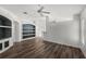 Bright, open living room with built-in shelving and modern ceiling fan at 2085 Friar Tuck Ln, Orange City, FL 32763