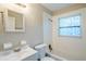 Bathroom featuring a single sink vanity, toilet, bathtub and a window at 2311 Olivet Ave, Leesburg, FL 34748