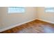 Bedroom featuring wood-look floors, neutral walls and a window for natural light at 2311 Olivet Ave, Leesburg, FL 34748