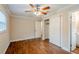 Comfortable bedroom with wood-look floors, ceiling fan and closet space at 2311 Olivet Ave, Leesburg, FL 34748