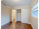 Bedroom with wood-look floors, large window and closet space at 2311 Olivet Ave, Leesburg, FL 34748