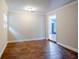 Bright, open bedroom featuring neutral walls, wood-look floors and white trim at 2311 Olivet Ave, Leesburg, FL 34748