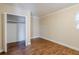 Empty bedroom featuring wood-look flooring, neutral walls, and an open closet at 2311 Olivet Ave, Leesburg, FL 34748