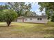 Charming single-story home with a well-manicured lawn and mature trees at 2311 Olivet Ave, Leesburg, FL 34748
