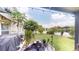 Spacious backyard with a covered patio, pond, and serene lake view at 2506 Shelby Cir, Kissimmee, FL 34743