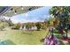 Lush backyard featuring a hammock, swing and serene lake view at 2506 Shelby Cir, Kissimmee, FL 34743