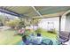 Relaxing backyard with covered patio, string lights, and white fence line at 2506 Shelby Cir, Kissimmee, FL 34743