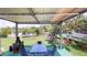 Backyard oasis featuring covered patio, dining area, hammock, swing and lake views at 2506 Shelby Cir, Kissimmee, FL 34743