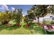 Lush backyard featuring mature trees, a swing, and a white picket fence at 2506 Shelby Cir, Kissimmee, FL 34743