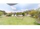 Lush backyard oasis with a lake view, a white fence, and a relaxing hammock at 2506 Shelby Cir, Kissimmee, FL 34743