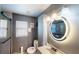 Nicely lit bathroom with modern vanity, a shower with glass door, and toilet at 2506 Shelby Cir, Kissimmee, FL 34743