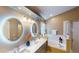 Bright bathroom featuring modern lighting, double vanity, and soaking tub at 2506 Shelby Cir, Kissimmee, FL 34743