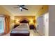 Spacious bedroom featuring a dark wood bed set and view into the connected bathroom at 2506 Shelby Cir, Kissimmee, FL 34743