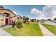 Charming front yard with lush grass and well-maintained landscaping at 2506 Shelby Cir, Kissimmee, FL 34743