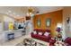 Comfortable living room with a red sofa, tile flooring, and an open layout at 2506 Shelby Cir, Kissimmee, FL 34743