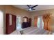 Spacious main bedroom featuring large closet, dresser, and French doors to exterior at 2506 Shelby Cir, Kissimmee, FL 34743