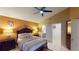Spacious main bedroom featuring a king bed, ensuite bathroom, and walk-in closet at 2506 Shelby Cir, Kissimmee, FL 34743
