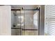 Modern shower featuring gray tile, glass doors and a mounted shower head at 2506 Shelby Cir, Kissimmee, FL 34743