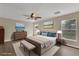 This staged bedroom is awash with natural light and features neutral decor and hardwood floors at 2963 Beckwith St, Deltona, FL 32738