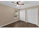 Clean bedroom with hardwood floors, a window, a ceiling fan, and closet space at 2963 Beckwith St, Deltona, FL 32738