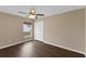 Bedroom featuring hardwood floors, a window, a ceiling fan, and closet space at 2963 Beckwith St, Deltona, FL 32738