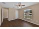 Bright bedroom with hardwood floors, ceiling fan, and a large window offering ample natural light at 2963 Beckwith St, Deltona, FL 32738