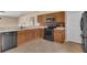 Classic kitchen features wood cabinets, stainless steel microwave, and a black range at 2963 Beckwith St, Deltona, FL 32738