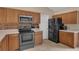 Kitchen boasts wooden cabinets, a stainless steel microwave, and a black refrigerator at 2963 Beckwith St, Deltona, FL 32738