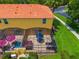 Aerial view of yellow townhome with screened patio, hot tub, and patio furniture at 3002 Secret Lake Dr, Kissimmee, FL 34747