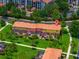 Overhead view of colorful townhomes, lush landscaping, and sidewalks at 3002 Secret Lake Dr, Kissimmee, FL 34747