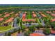 Aerial view of a townhome community featuring scenic landscaping, assigned parking, and manicured greenery at 3002 Secret Lake Dr, Kissimmee, FL 34747