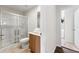 Clean bathroom featuring a glass shower, toilet, and sink with a wood grain vanity at 3002 Secret Lake Dr, Kissimmee, FL 34747