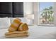 Cozy bedroom with plush bedding, stylish headboard, and bright window with tropical views at 3002 Secret Lake Dr, Kissimmee, FL 34747