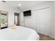Bright bedroom with a large closet, flat-screen TV, and comfortable queen-size bed at 3002 Secret Lake Dr, Kissimmee, FL 34747