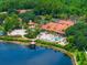 Aerial view of community pool, clubhouse, and lakefront views at 3002 Secret Lake Dr, Kissimmee, FL 34747