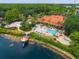 Aerial view of community pool and amenities, waterfront property, and lush landscaping at 3002 Secret Lake Dr, Kissimmee, FL 34747