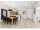 An open dining area with modern table and chairs, with an adjacent open kitchen, perfect for Gathering gatherings at 3002 Secret Lake Dr, Kissimmee, FL 34747