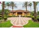 Clubhouse entrance with landscaping, palm trees, and beautiful walkway to the building at 3002 Secret Lake Dr, Kissimmee, FL 34747