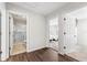 Bright hallway featuring hard wood floors, and doorways to the bathroom and a bedroom at 3002 Secret Lake Dr, Kissimmee, FL 34747