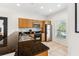 Well-lit kitchen with wooden cabinets, stainless steel appliances, and granite countertop at 3002 Secret Lake Dr, Kissimmee, FL 34747