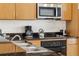Well-equipped kitchen with stainless steel appliances, dark countertops, and cabinetry at 3002 Secret Lake Dr, Kissimmee, FL 34747