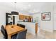 Kitchen and dining area with wooden cabinetry, stainless steel appliances, and granite countertops at 3002 Secret Lake Dr, Kissimmee, FL 34747