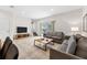Comfortable living room with tile floors, sofas, TV and stairs leading to second floor at 3002 Secret Lake Dr, Kissimmee, FL 34747