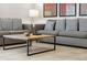 Comfortable living room featuring neutral-toned sofas, modern coffee table, and tiled flooring at 3002 Secret Lake Dr, Kissimmee, FL 34747
