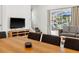 Open-concept living and dining area with modern furnishings, lots of light, and a view to outdoor space at 3002 Secret Lake Dr, Kissimmee, FL 34747