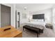 Main bedroom with a grey upholstered headboard, bench, and lots of natural light at 3002 Secret Lake Dr, Kissimmee, FL 34747