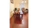 Cozy dining room with hardwood floors, a wooden dining set, and a comfortable recliner nearby at 319 N Scenic Hwy, Frostproof, FL 33843