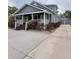 Charming two-story home with a front porch, landscaped yard, and a private driveway at 319 N Scenic Hwy, Frostproof, FL 33843